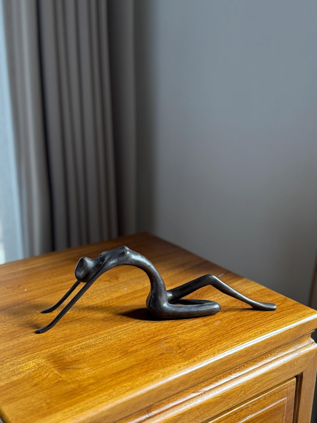 Edge-Sitting Brass Figurine