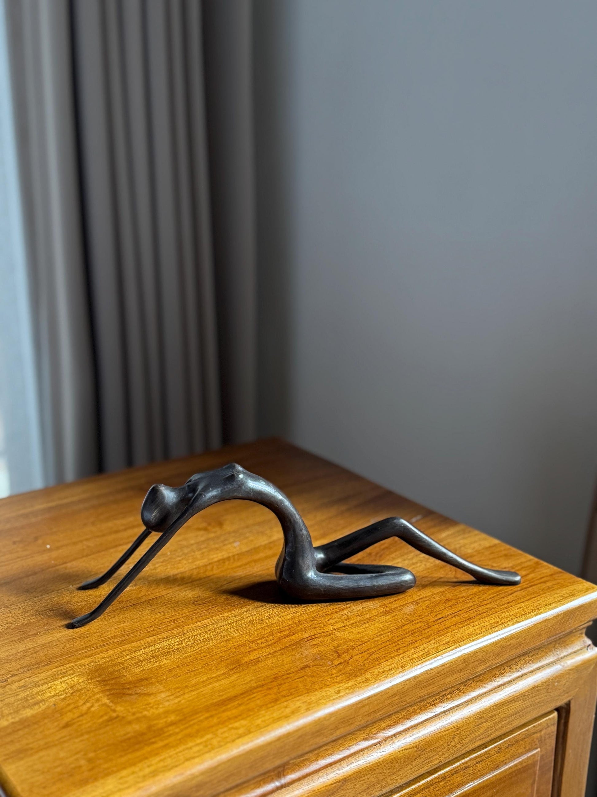 Edge-Sitting Brass Figurine