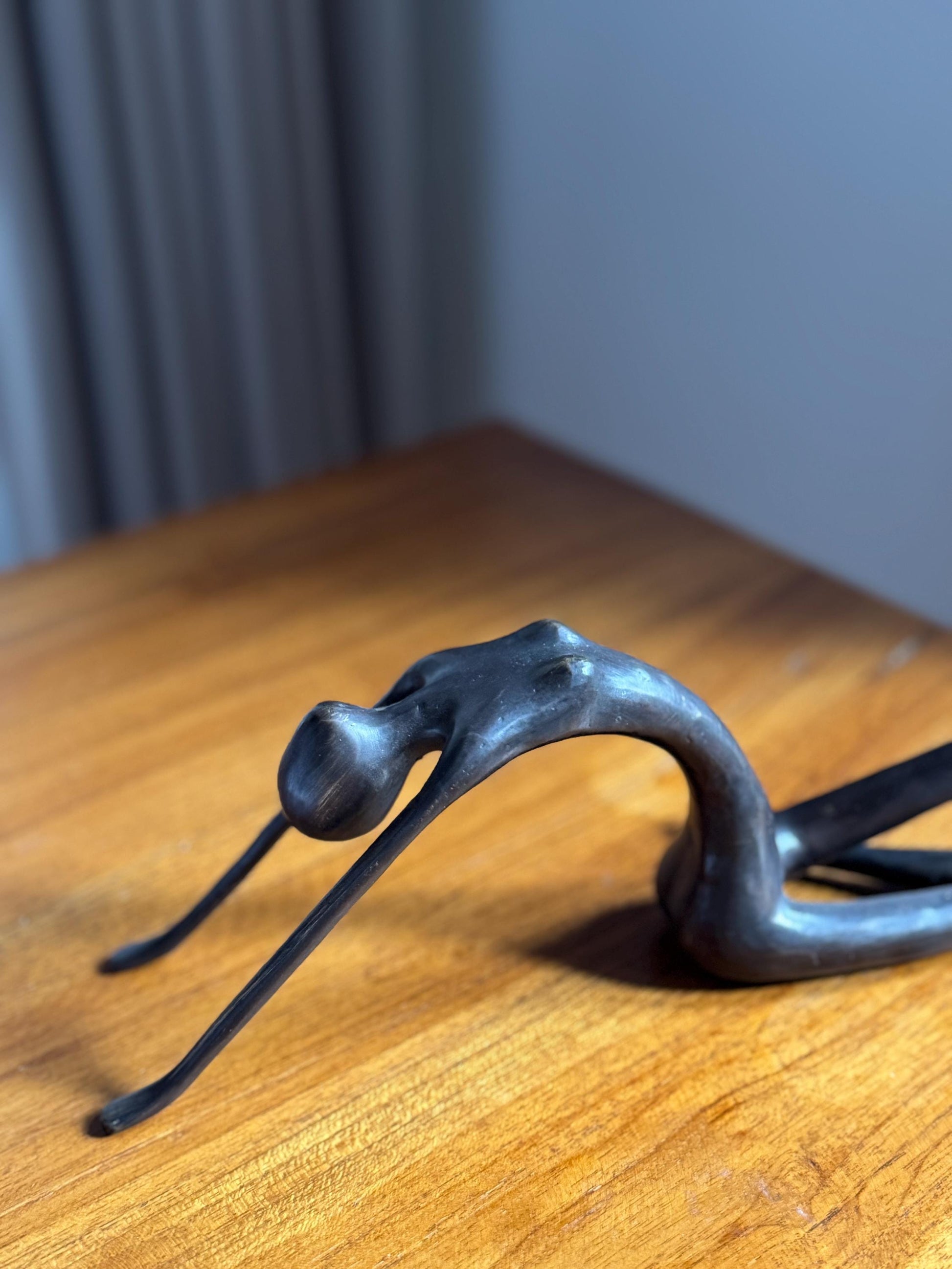 Edge-Sitting Brass Figurine