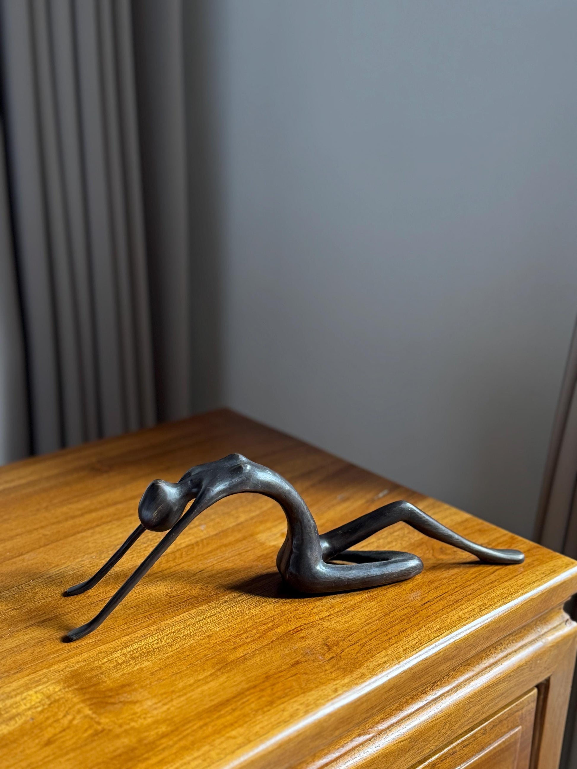 Edge-Sitting Brass Figurine