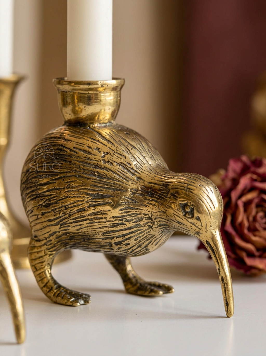 Close-up of textured brass feather detail on the kiwi bird candleholder