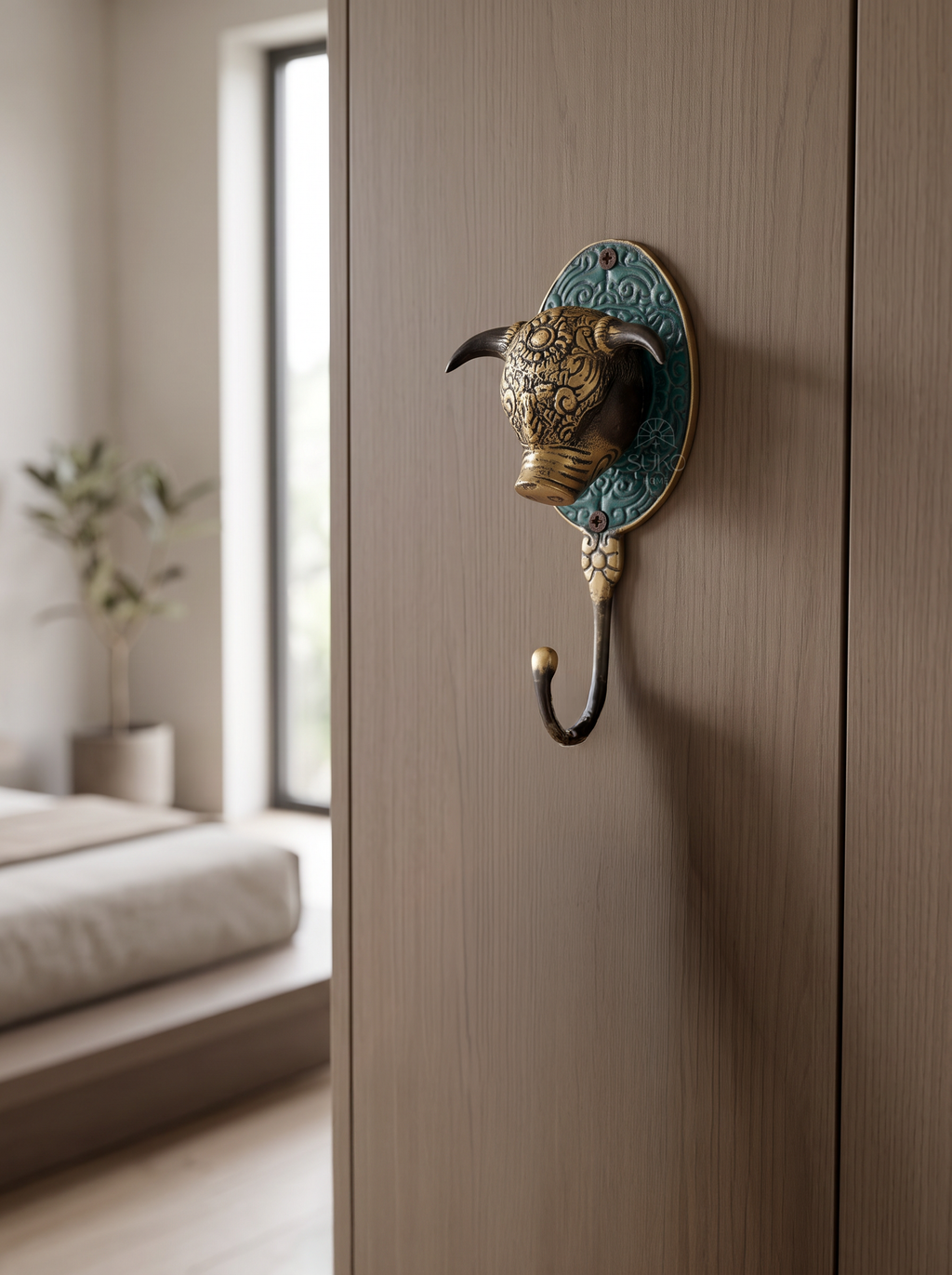 Brass bull head wall hook on embossed turquoise backplate