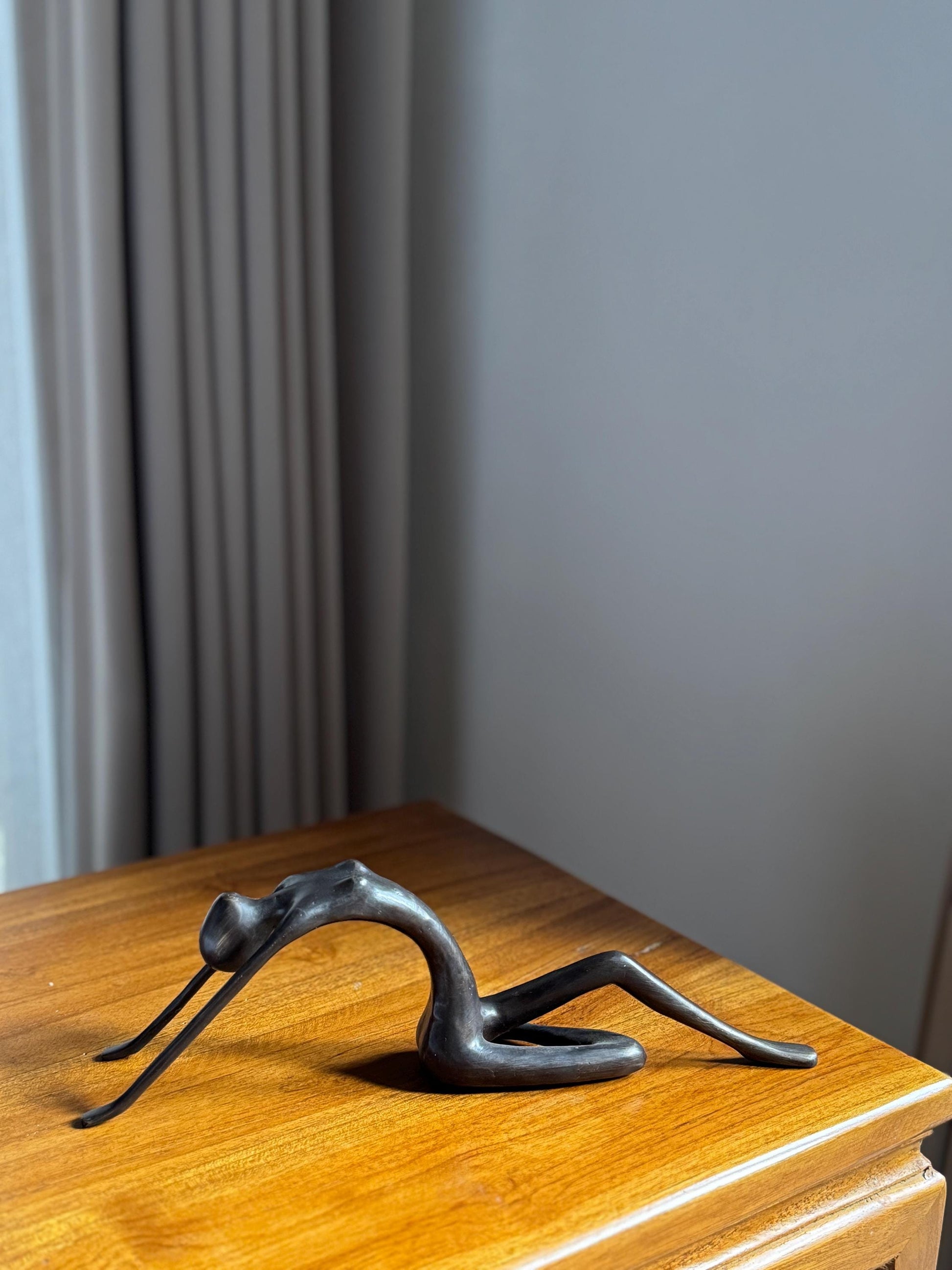 Edge-Sitting Brass Figurine