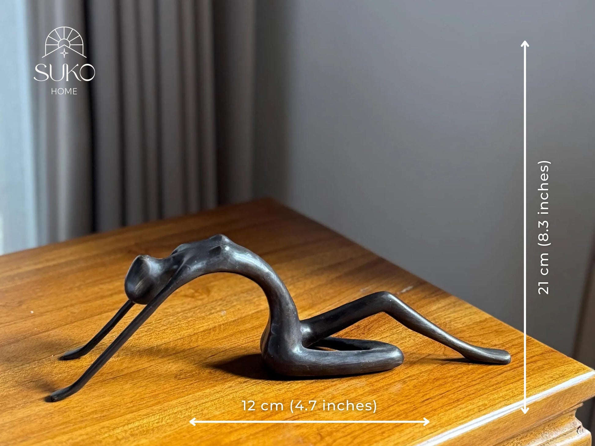 Edge-Sitting Brass Figurine