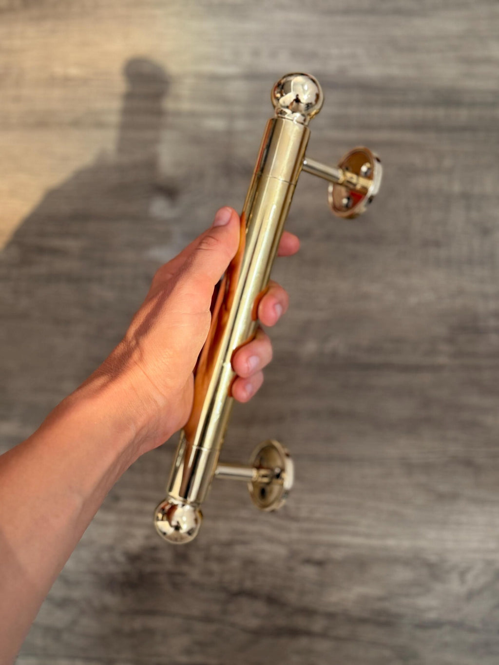 Brass door pull handle hand-finished by Indonesian artisans