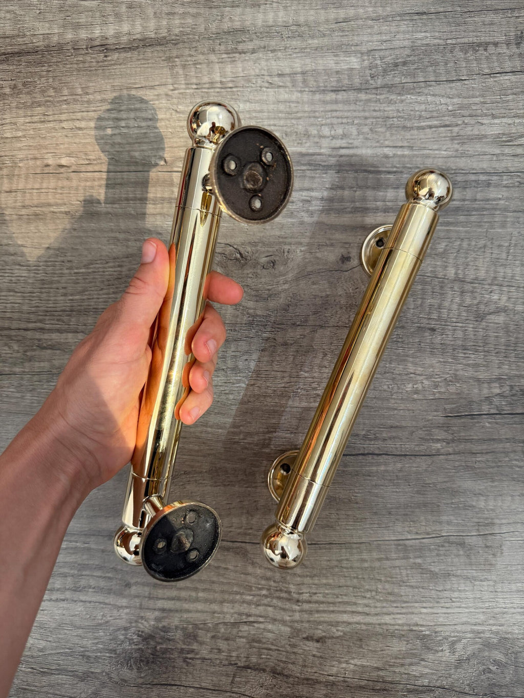 Rounded finial brass pull for hotel and boutique entrances