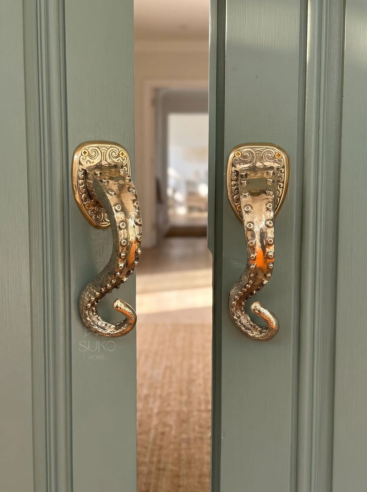 Handmade brass octopus tentacle door pull with curled tip