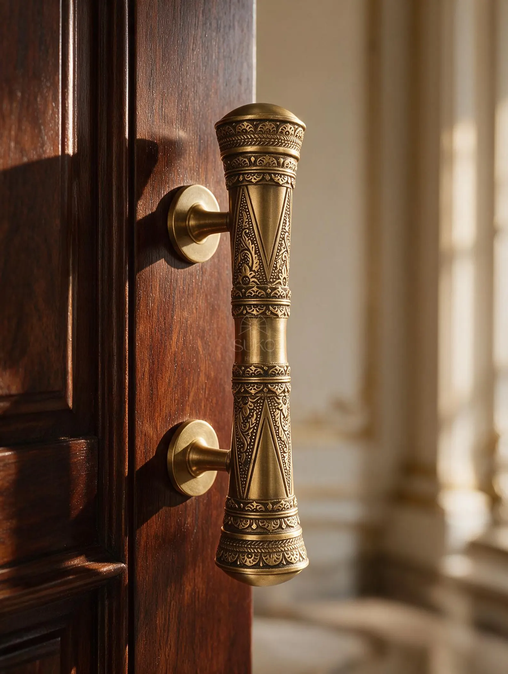 Engraved solid brass oriental pull handle mounted on a dark wooden door