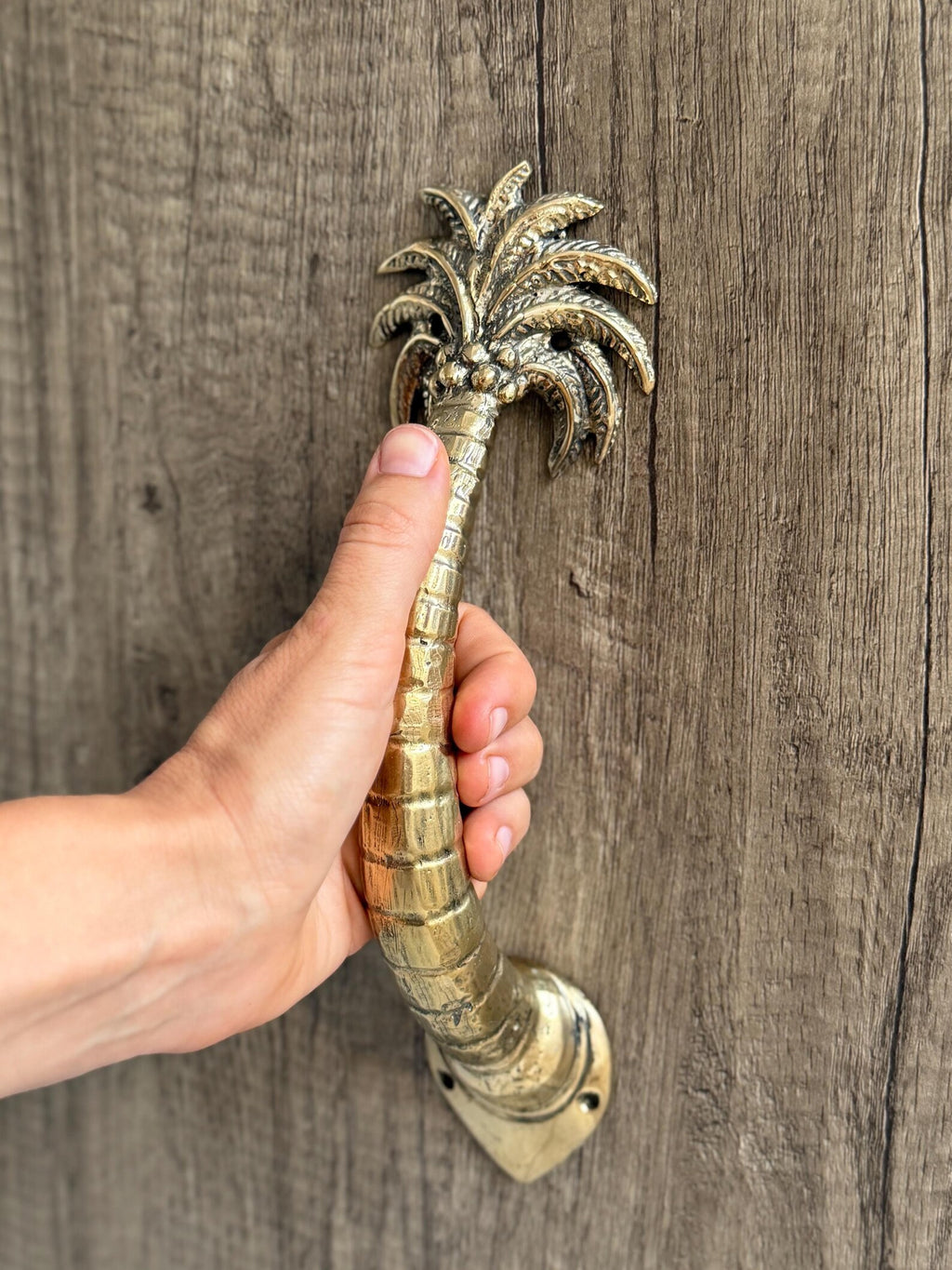 Brass palm tree door handle hand-finished by Indonesian artisans