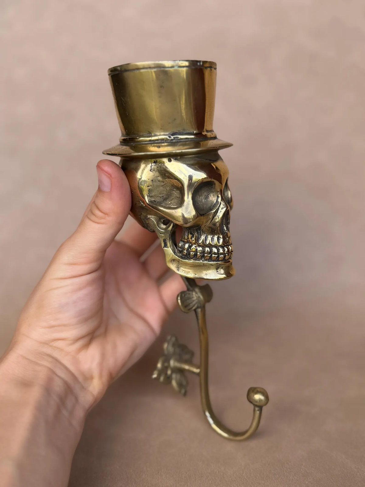 Close-up of the skull's side profile under a brass top hat