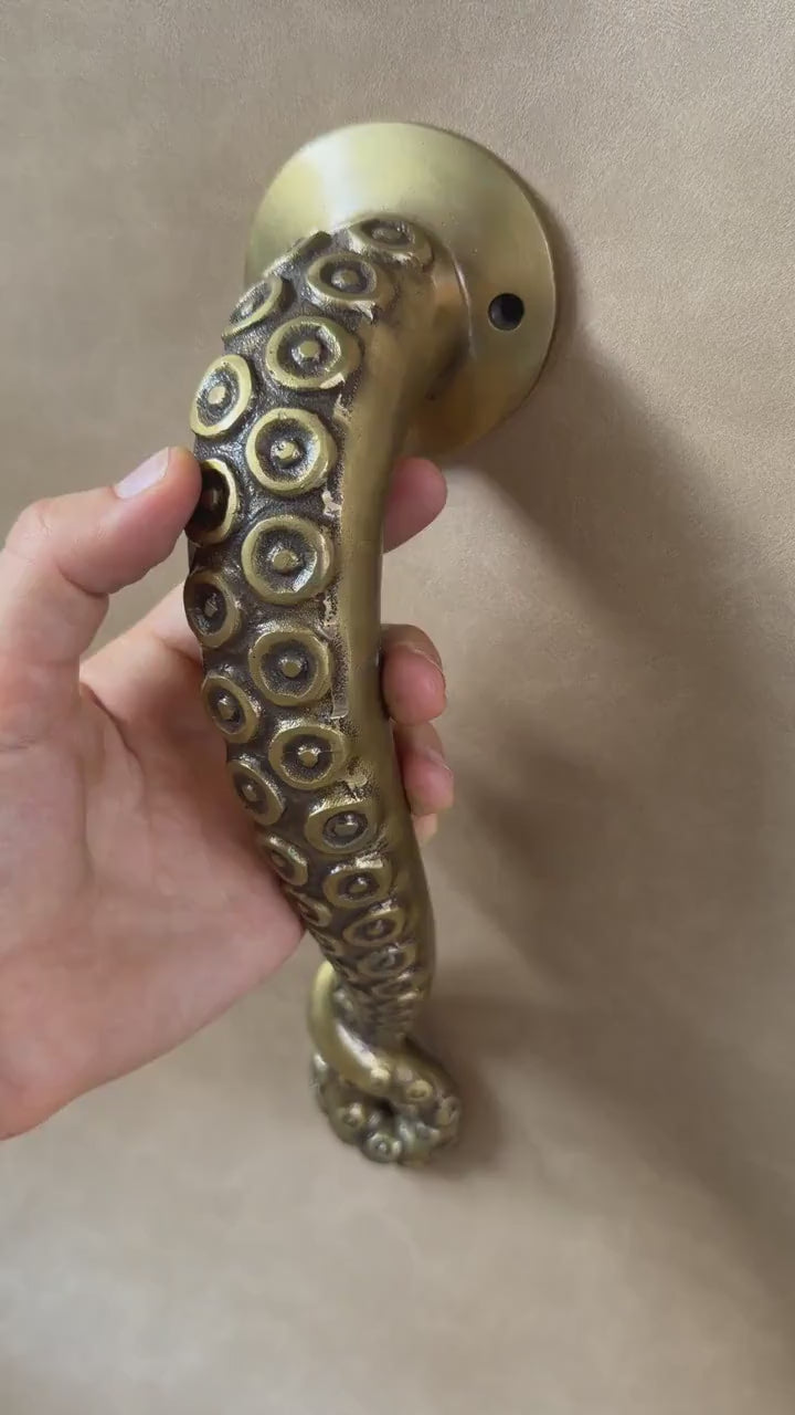 Video of a hand holding the brass octopus tentacle door handle